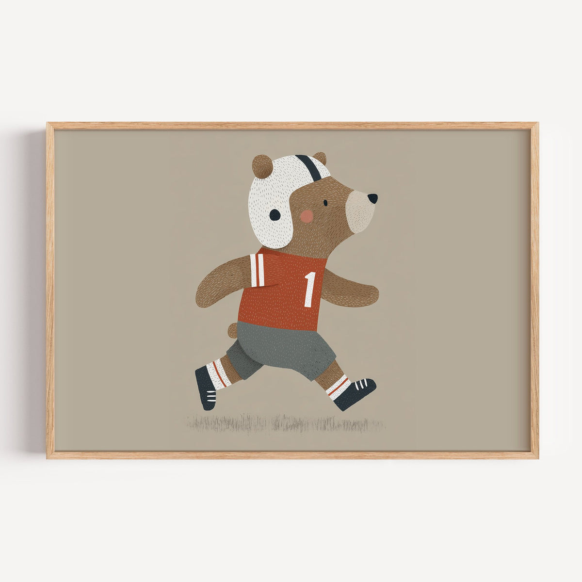 Landscape football bear number one nursery print in a light oak frame on a plain white wall