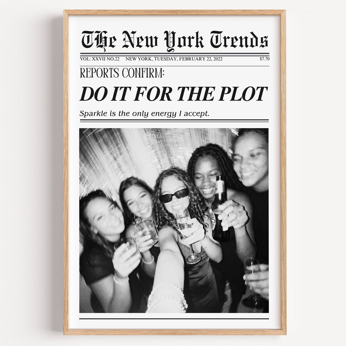 Five friends party selfie mock newspaper print in a light oak frame on a plain white wall