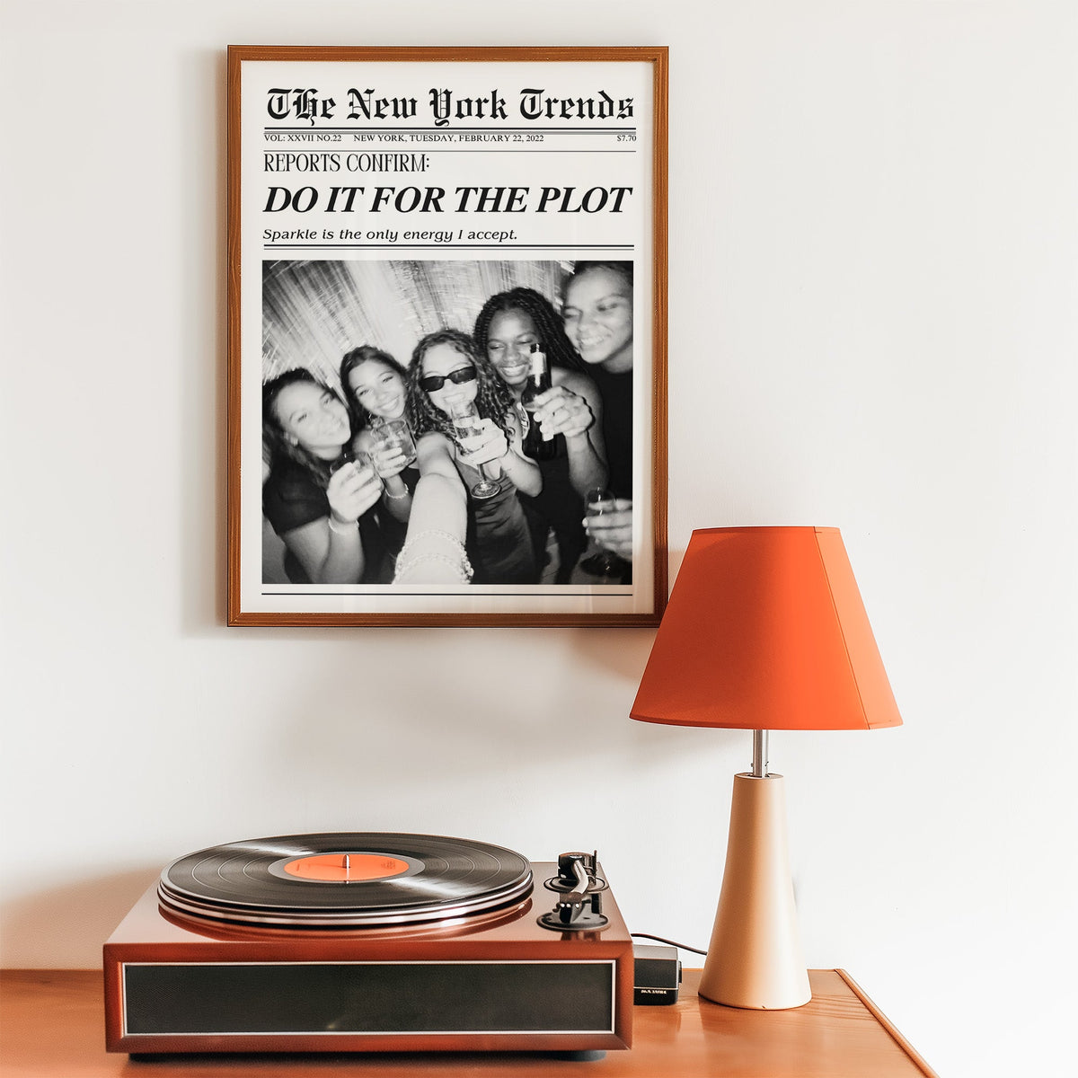 Five friends party selfie mock newspaper print in a walnut frame above a record player and orange lamp