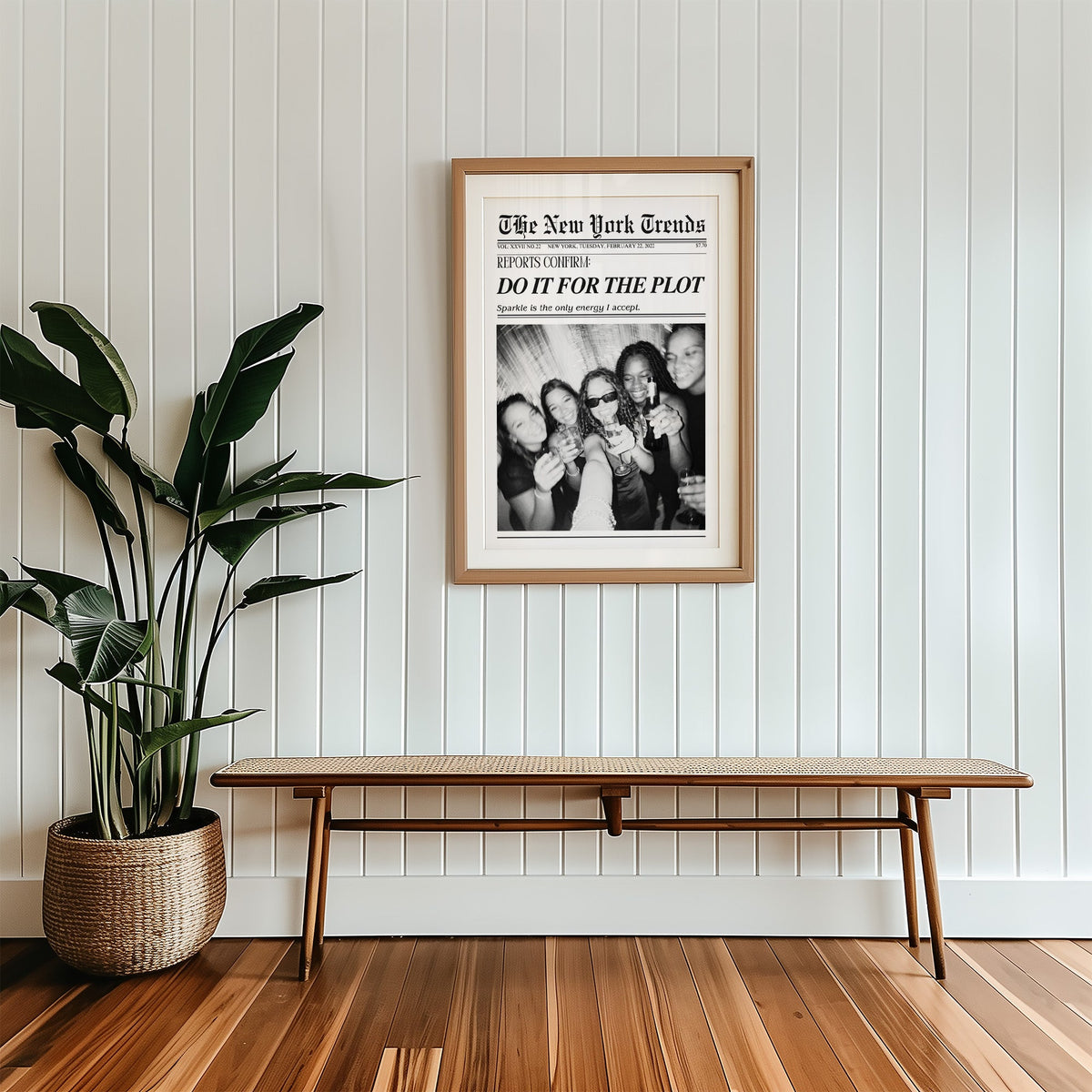 Five friends party selfie mock newspaper print in a wood frame with a white mat above a cane bench
