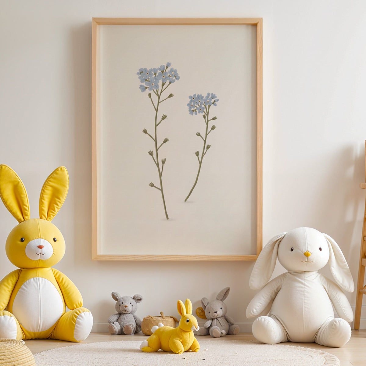 Two blue forget-me-not stems nursery print in an oak frame above yellow and white plush bunnies