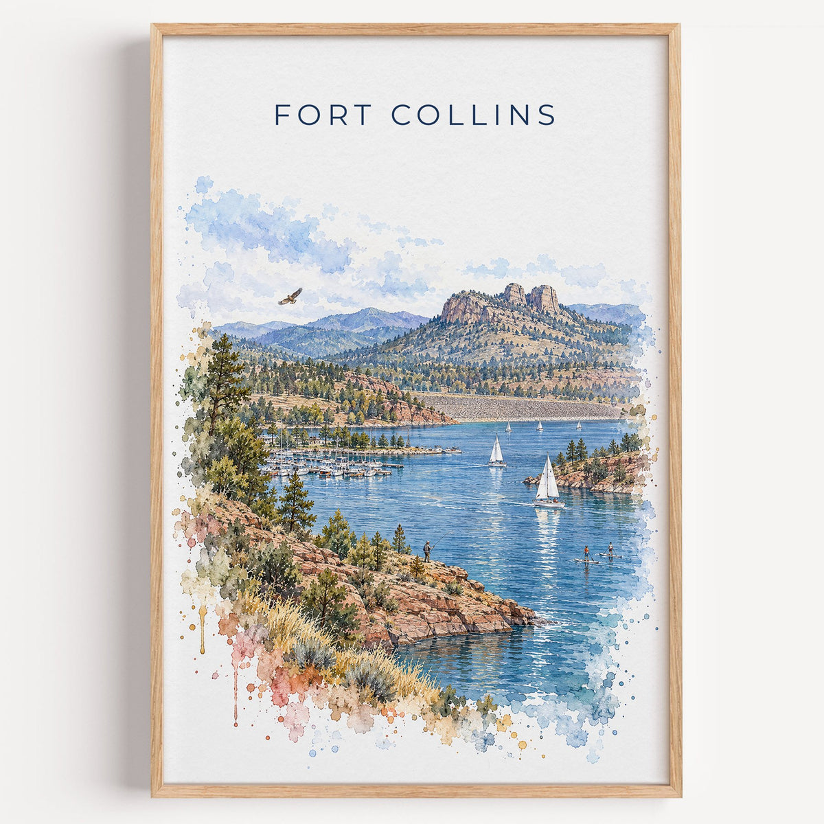 Fort Collins watercolor print in a light oak frame on a plain white wall