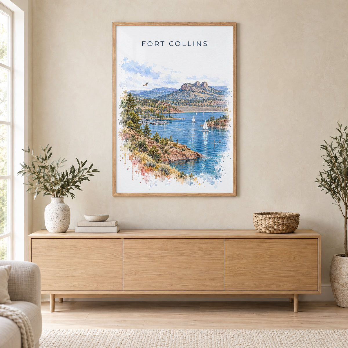 Fort Collins watercolor print in an oak frame above a light wood sideboard in a Scandinavian living room