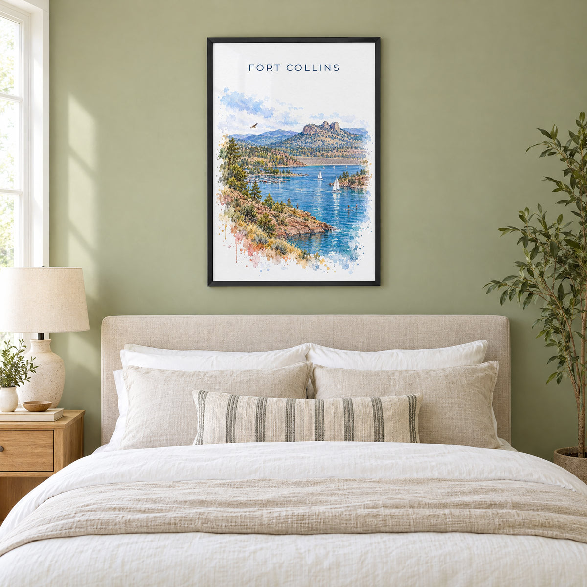 Fort Collins watercolor print in a black frame above an upholstered headboard in a sage green bedroom