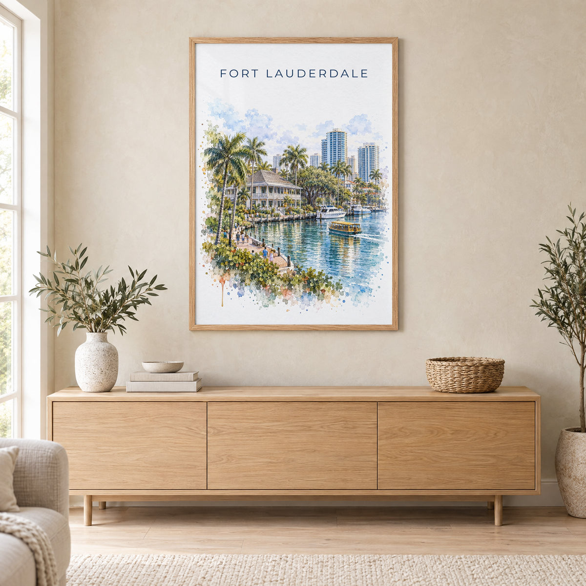 Fort Lauderdale watercolor print in an oak frame above a light wood sideboard in a Scandinavian living room