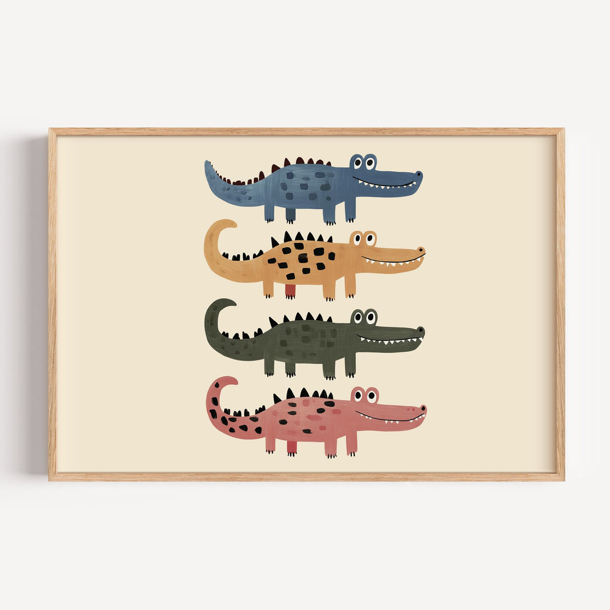 Landscape four stacked crocodiles nursery print in a light oak frame on a plain white wall