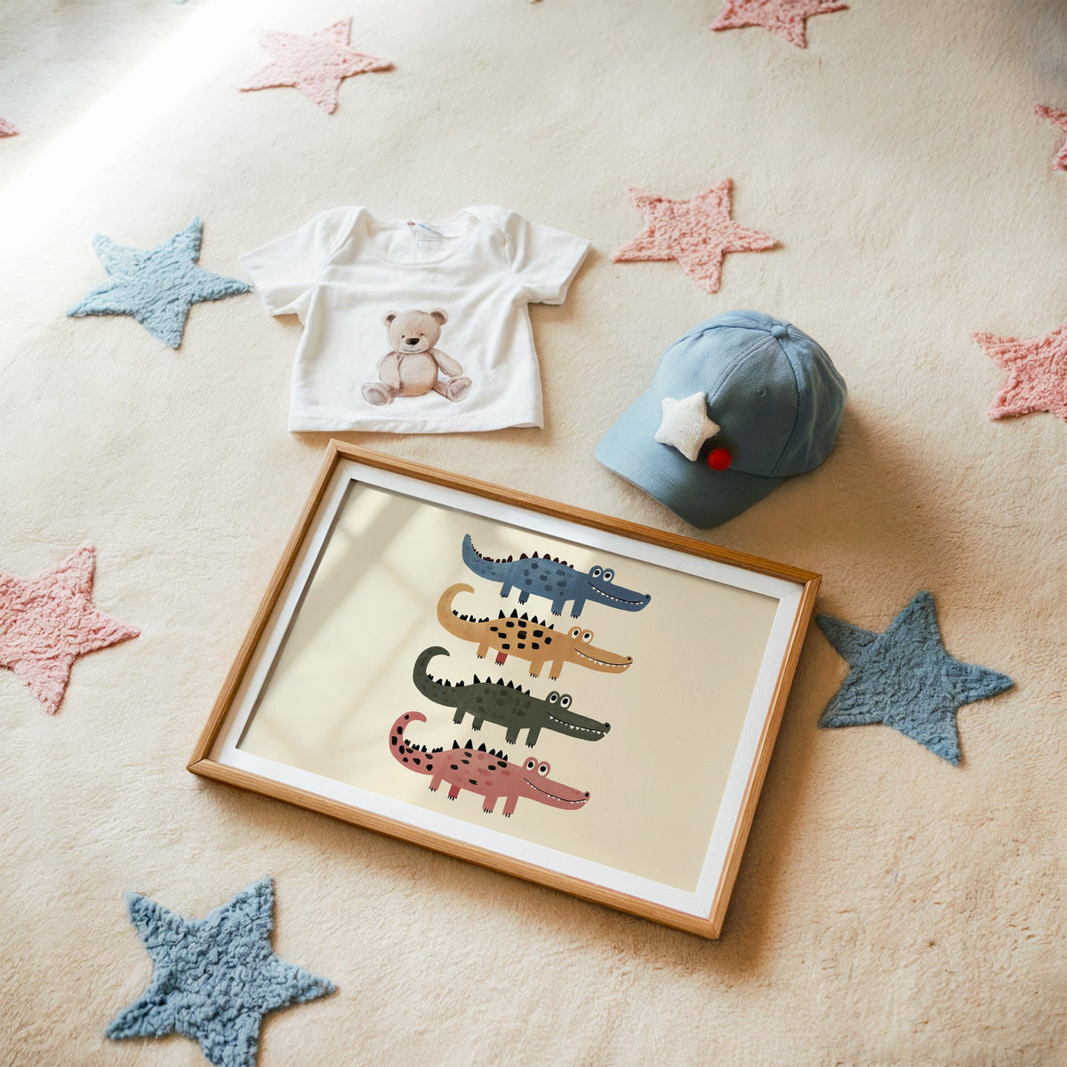Landscape four stacked crocodiles nursery print in a matted oak frame on a star rug with a baby tee