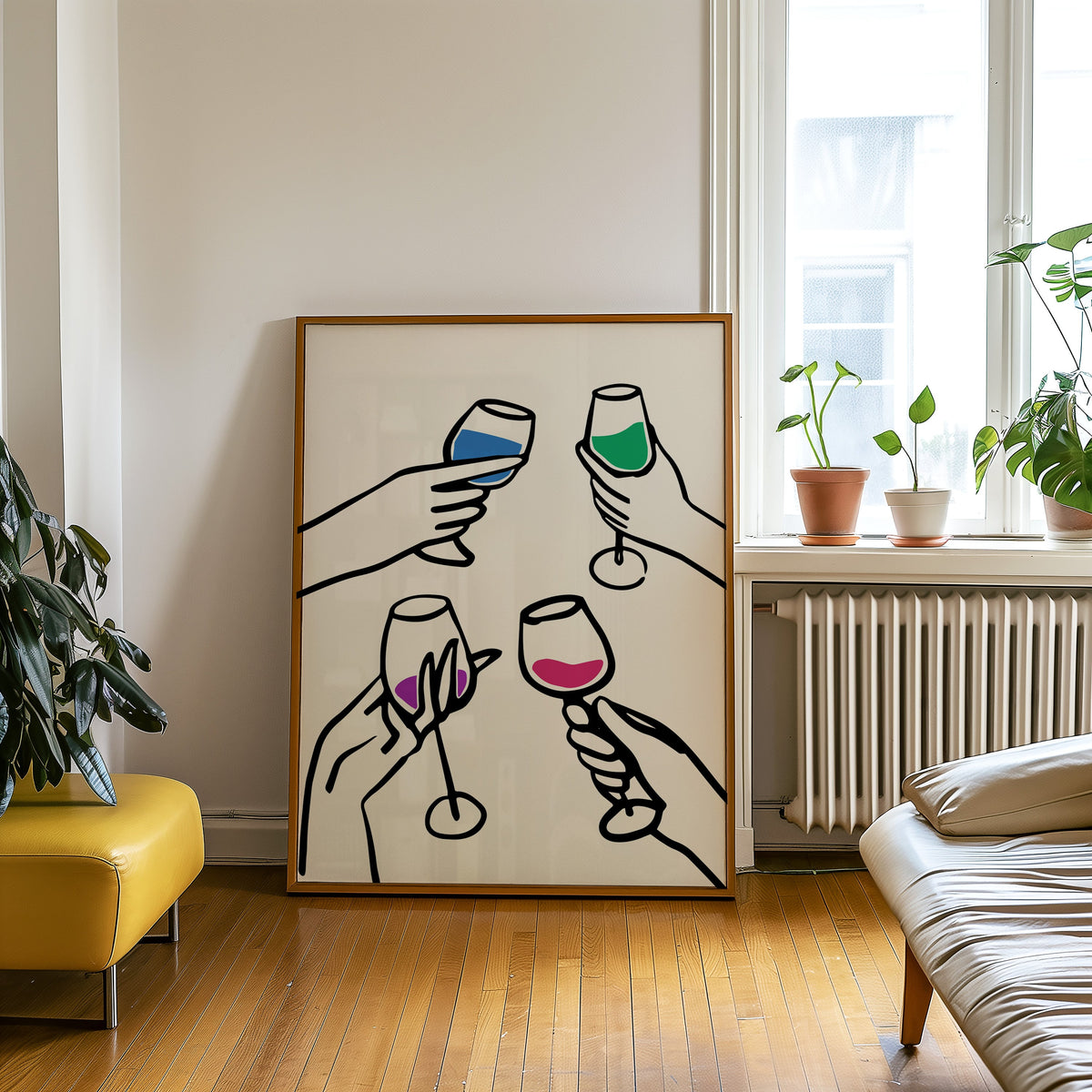 Four hands cheers colour pour print in an oak frame leaning on a wooden floor beside a yellow leather bench