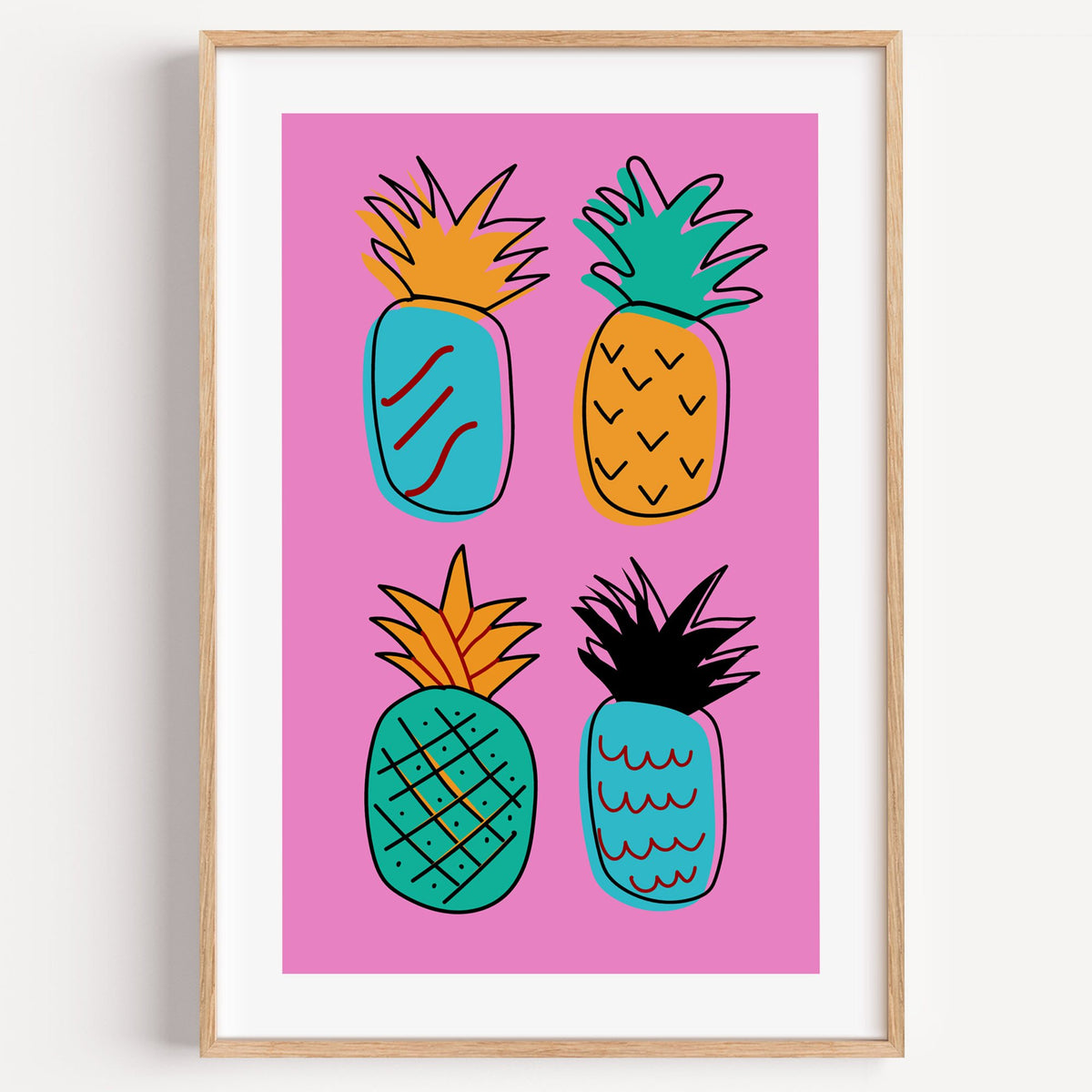 four patterned doodle pineapples hot pink print in a light oak frame on a plain white wall