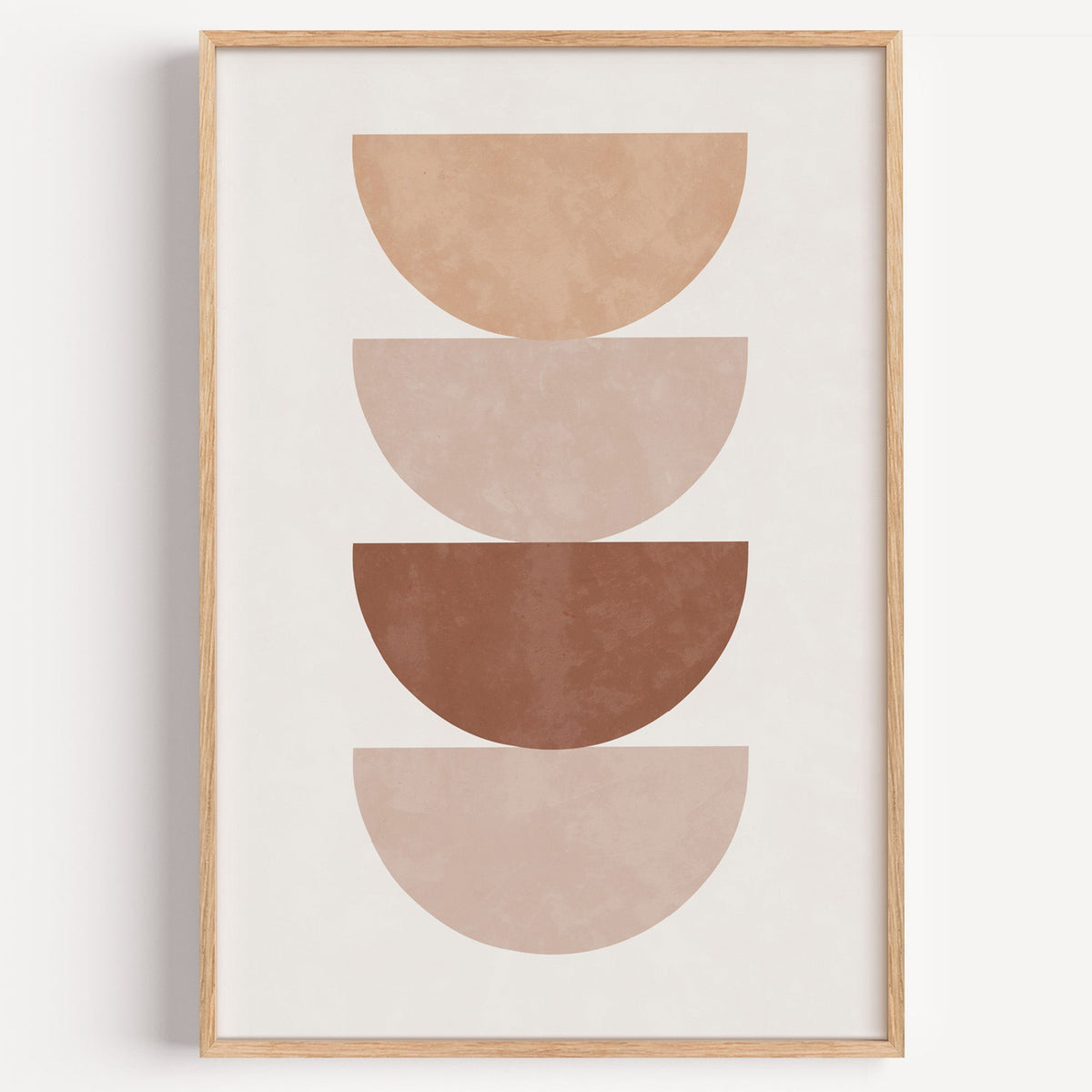 Four stacked terracotta half circles print in a light oak frame on a plain white wall