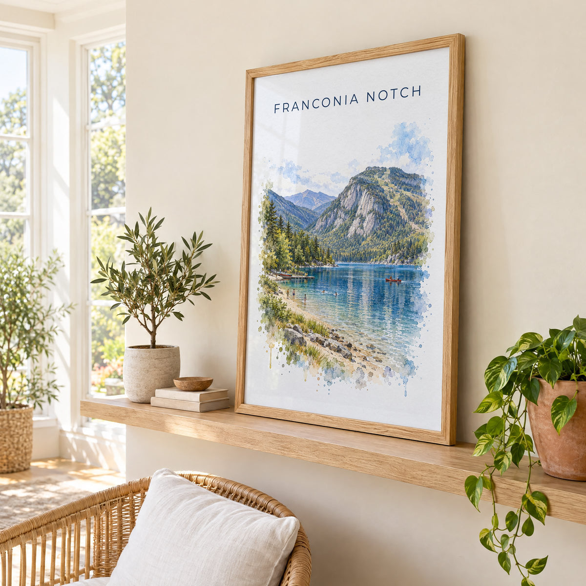 Franconia Notch watercolor print in an oak frame on a picture ledge in a sunlit sunroom