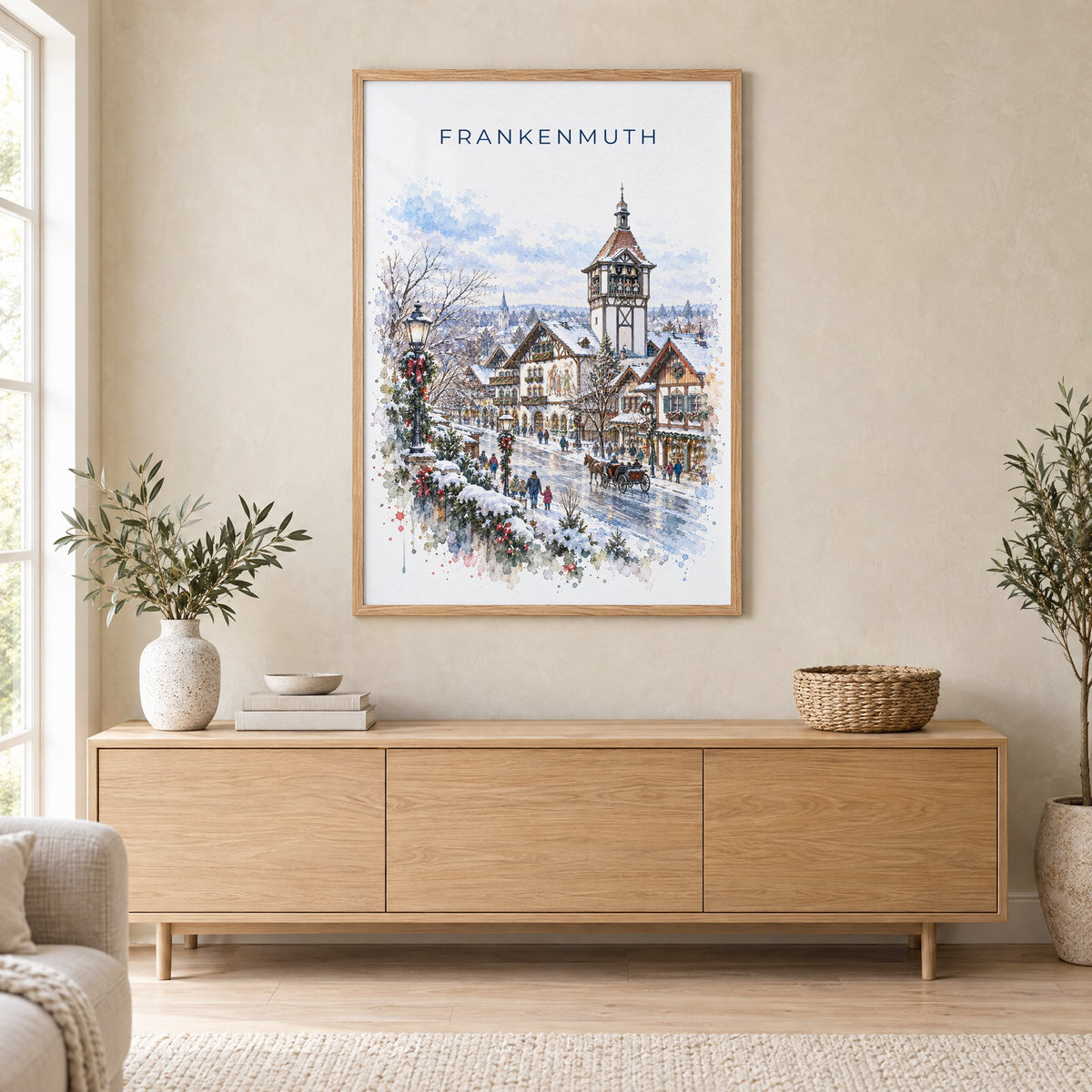 Frankenmuth watercolor print in an oak frame above a light wood sideboard in a Scandinavian living room