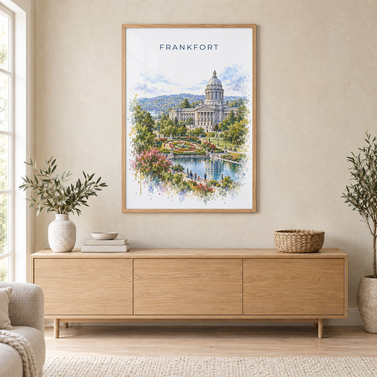 Frankfort, Kentucky watercolor print in an oak frame above a light wood sideboard in a Scandinavian living room