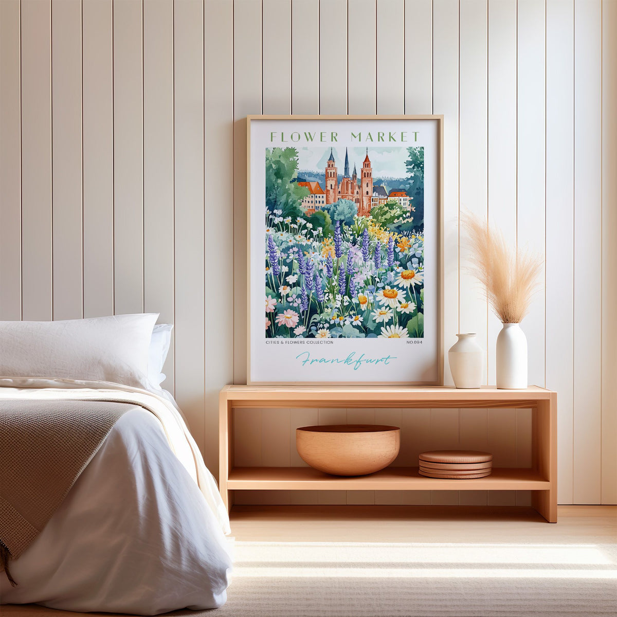 Frankfurt flower market print in an oak frame on a wood bench against a white shiplap bedroom wall with pampas grass