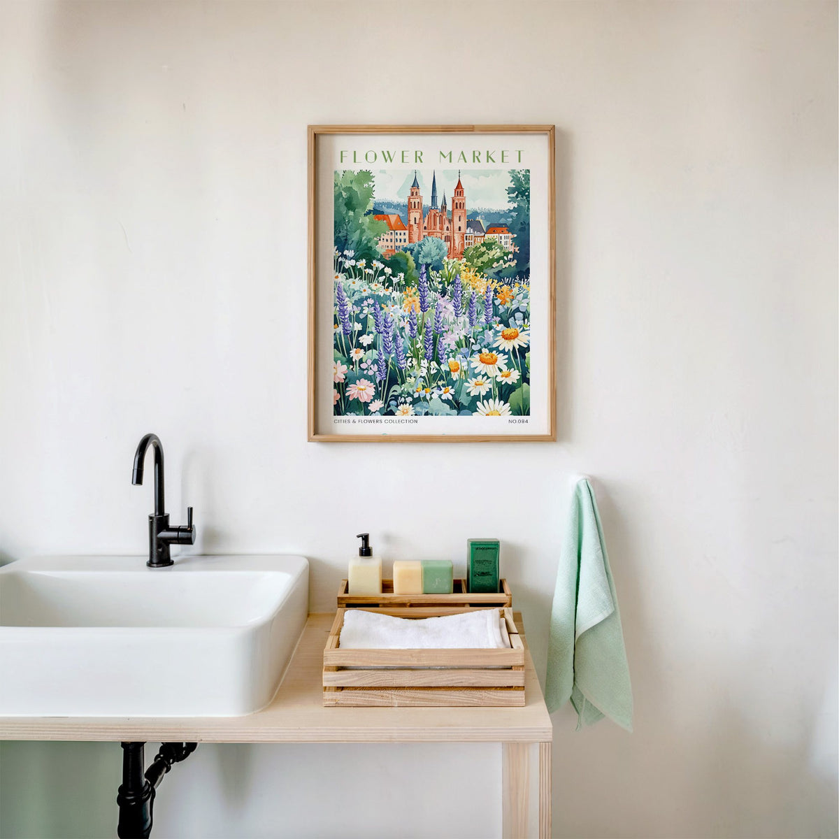 Frankfurt flower market print in an oak frame above a white bathroom sink with folded towels
