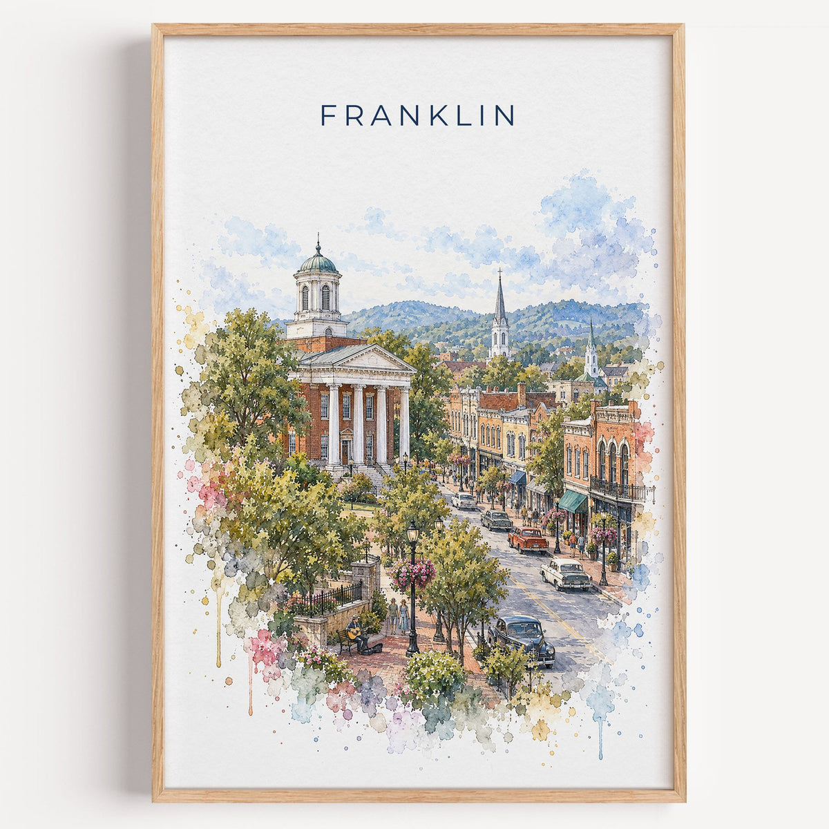Franklin, Tennessee watercolor print in a light oak frame on a plain white wall
