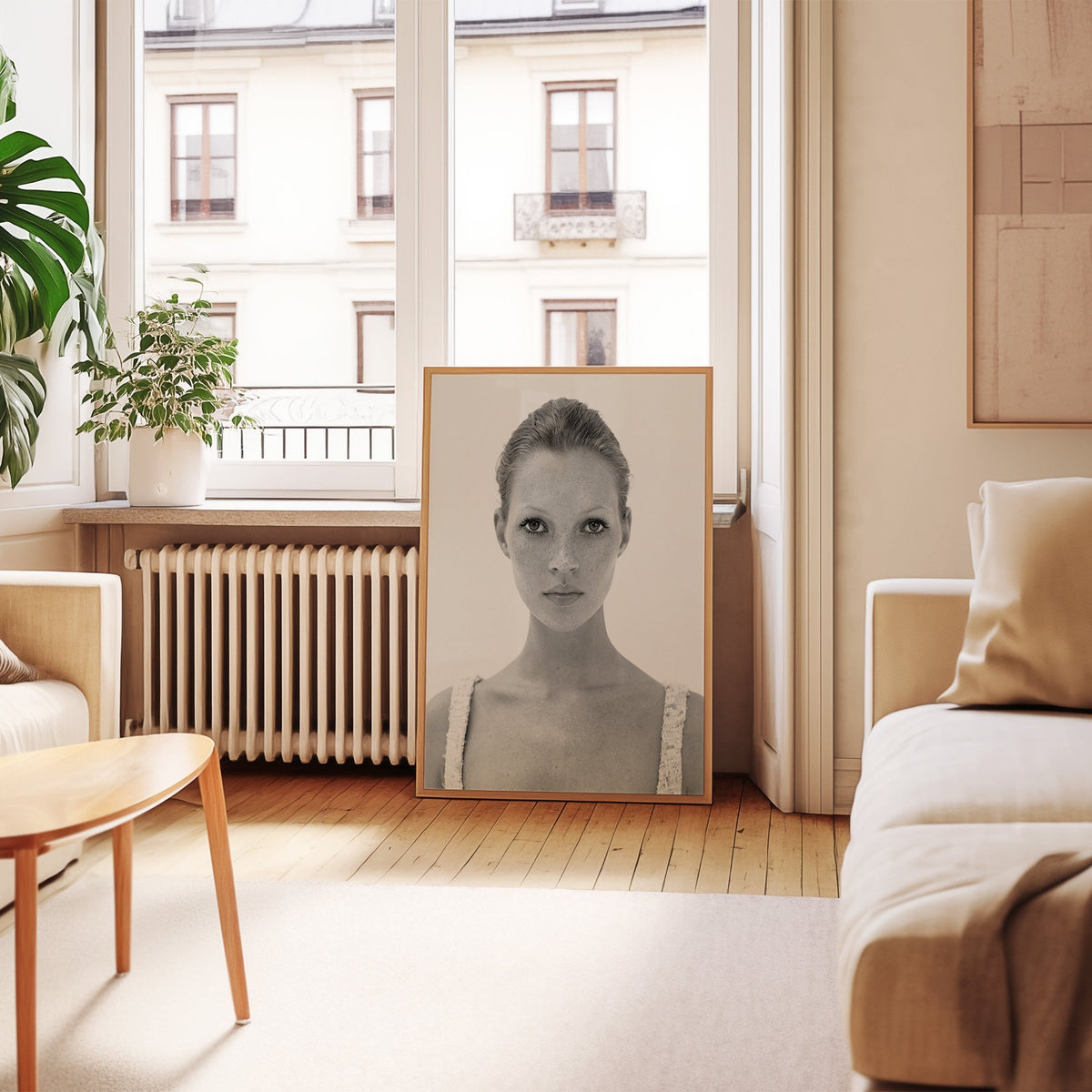 Freckled woman in lace tank top portrait print in an oak frame leaning by a French window in a living room
