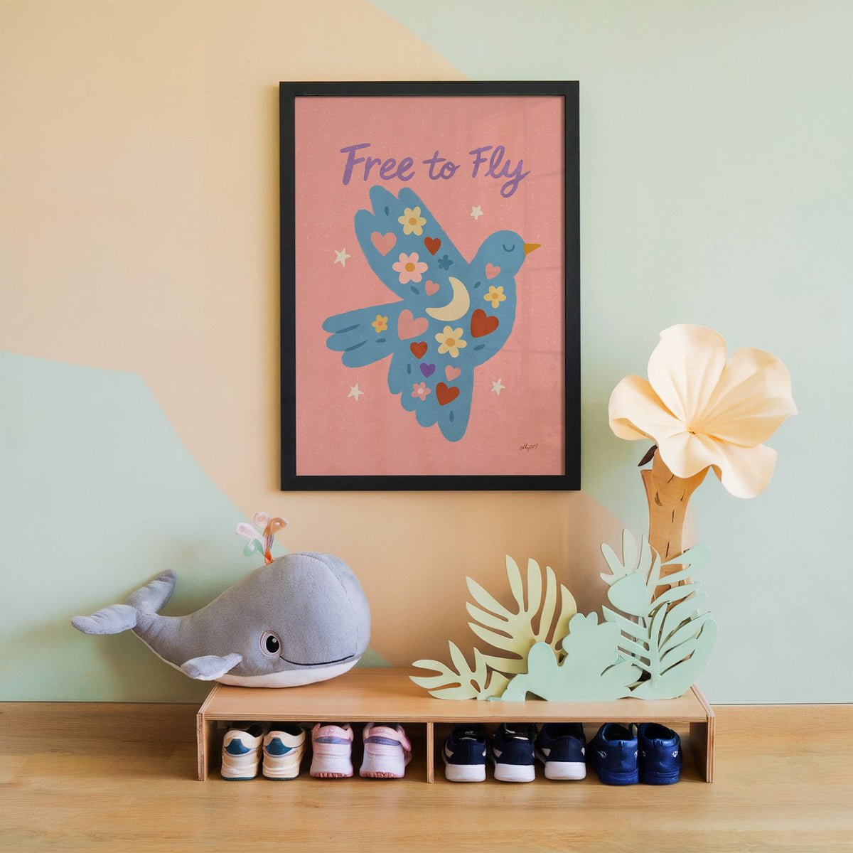 Folk blue bird free to fly nursery print in a black frame on a mint and peach wall above a whale plush