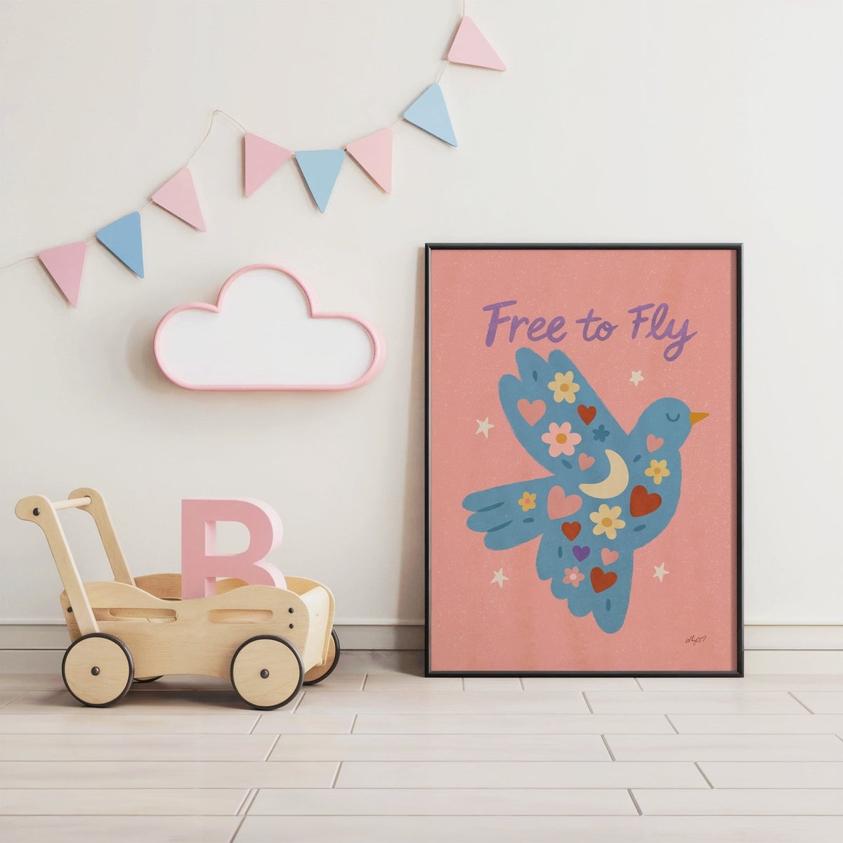 Folk blue bird free to fly nursery print in a black frame under pastel bunting by a wooden baby walker