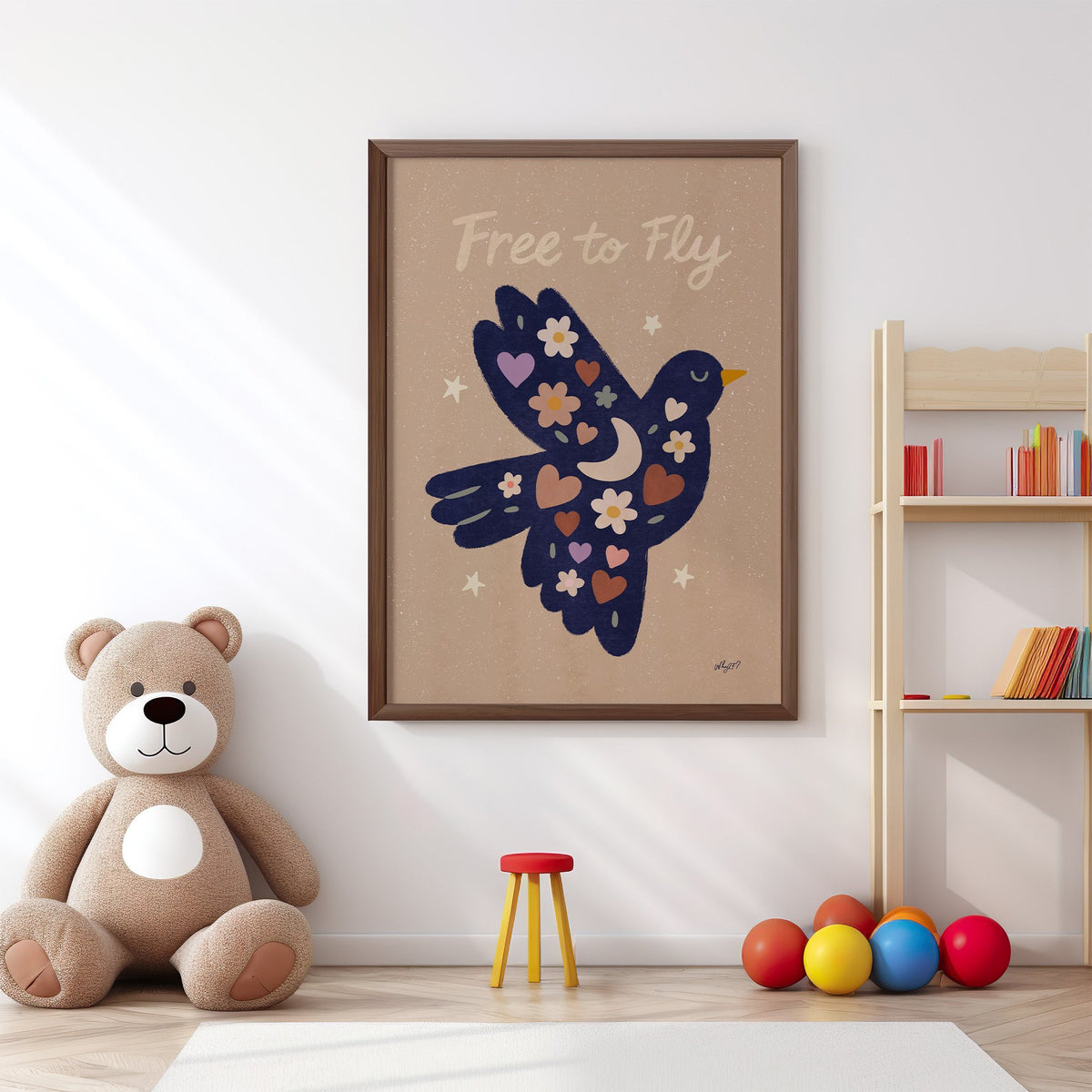 Navy folk bird free to fly nursery print in a walnut frame above a big teddy bear by a bookshelf