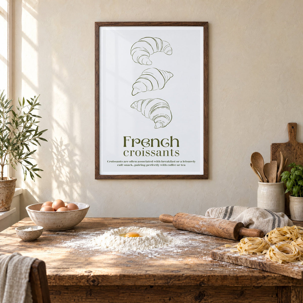 French croissants olive line print in a walnut frame above a rustic table set for making fresh pasta