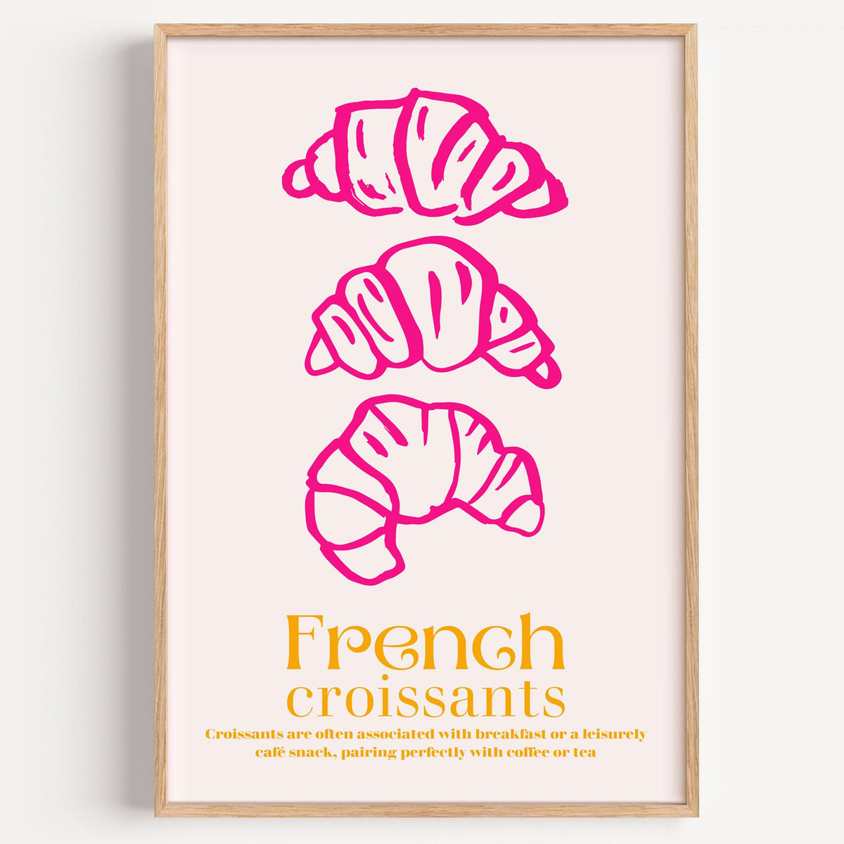 French croissants hot pink line print in a light oak frame on a plain white wall