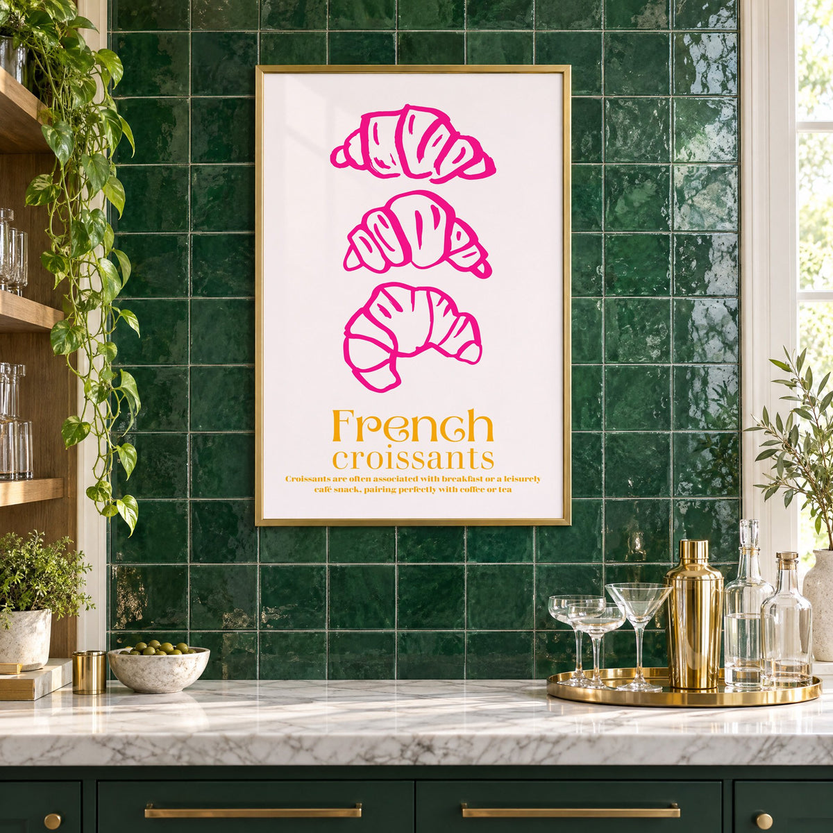 French croissants hot pink line print in a brass frame on emerald green tiles above a home bar with coupe glasses
