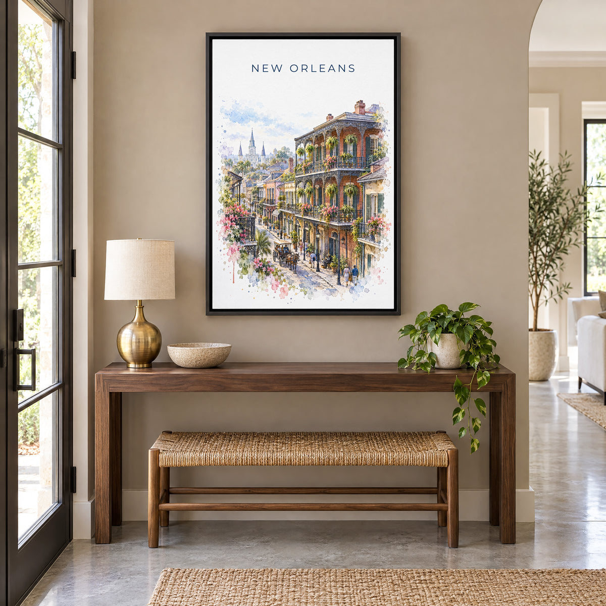 French Quarter New Orleans watercolor print as a black floater canvas above a walnut console and woven bench in an entryway
