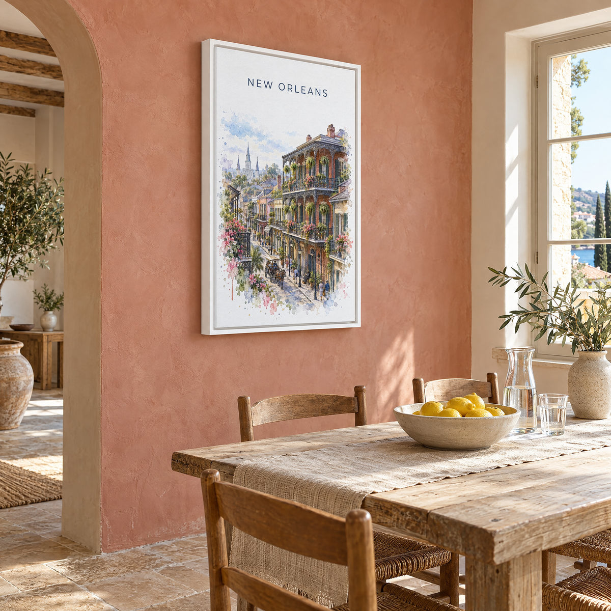 French Quarter New Orleans watercolor print as a white floater canvas on a terracotta wall above a rustic dining table