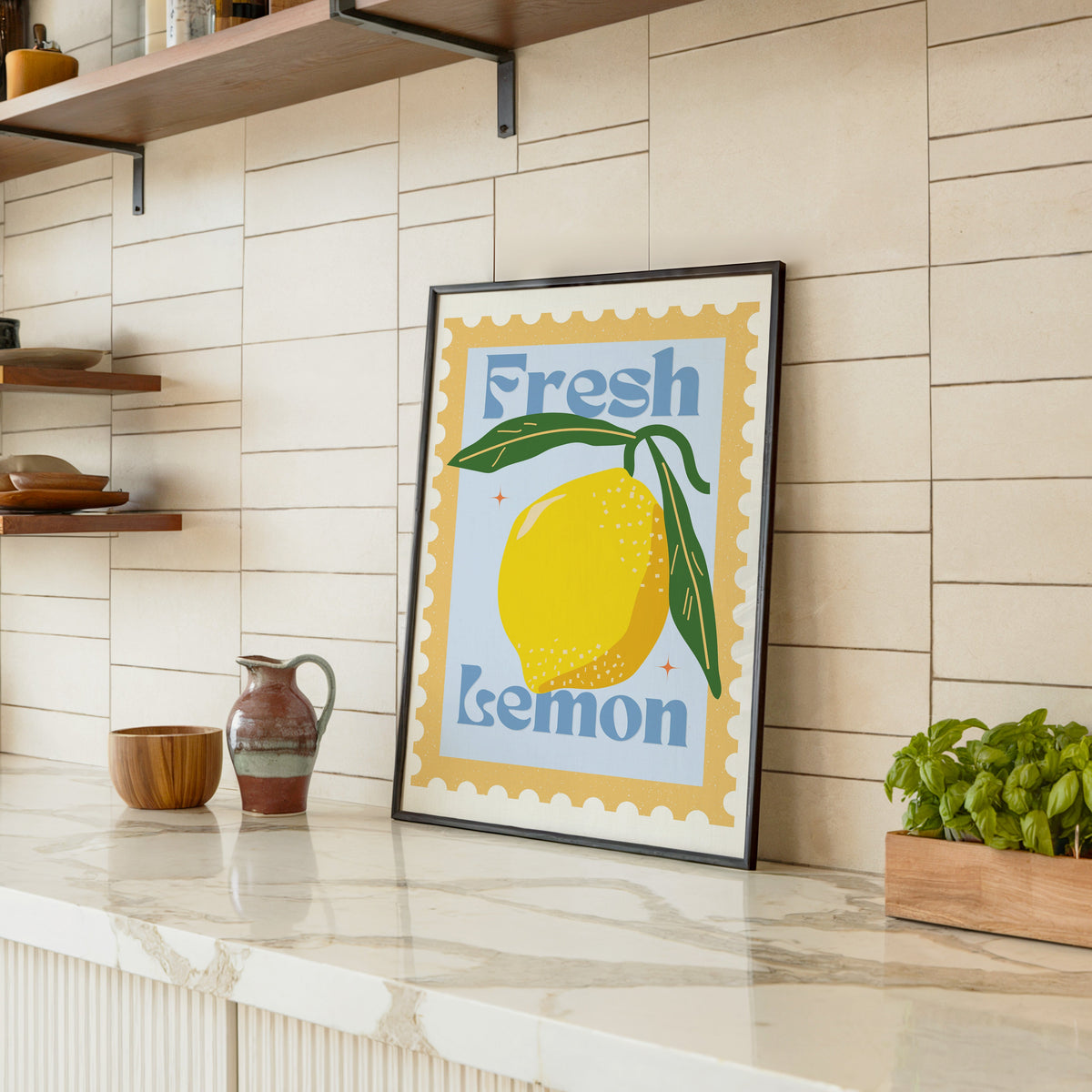 Fresh Lemon stamp print in a black frame leaning on a marble counter in a tiled kitchen