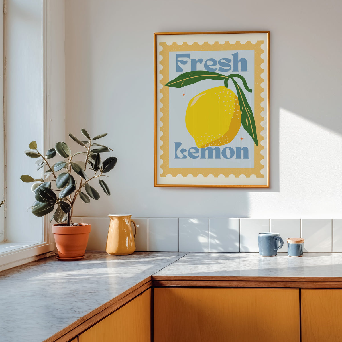 Fresh Lemon stamp print shown in a gold frame above a marble counter in a tan kitchen