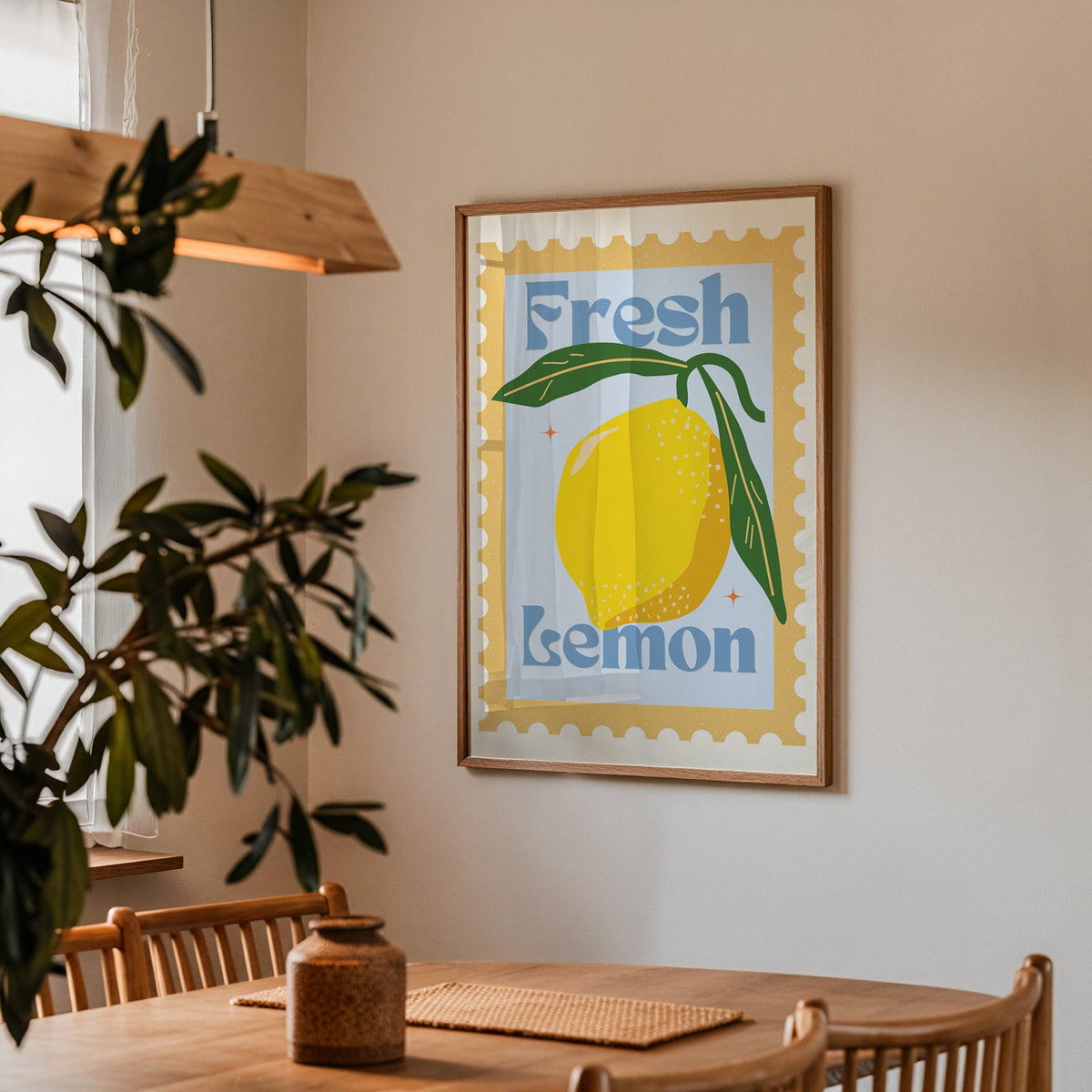 Fresh Lemon stamp print in a walnut frame above a dining table with olive branches