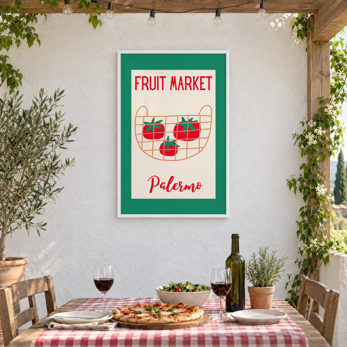 FRUIT MARKET Palermo tomato basket print in a white frame on a stucco wall above a checked-cloth table with pizza and red wine
