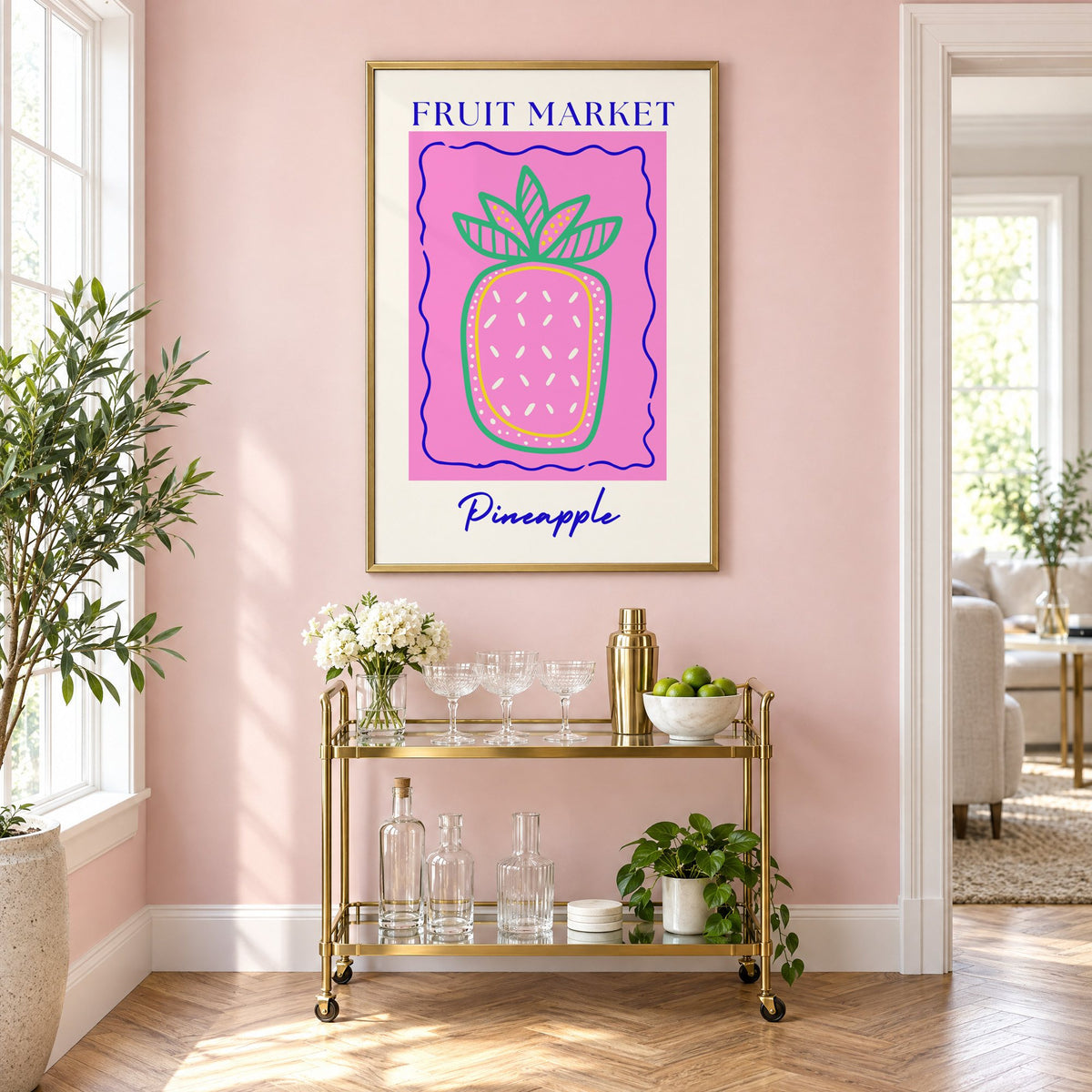 FRUIT MARKET Pineapple pink wavy frame print in a brass frame on a blush pink wall above a gold bar cart with glassware
