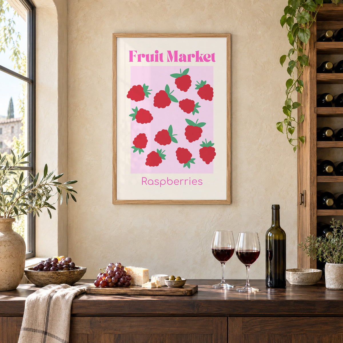 Fruit Market Raspberries pink panel print in an oak frame on a limewashed wall above a wine counter with red wine, cheese and grapes