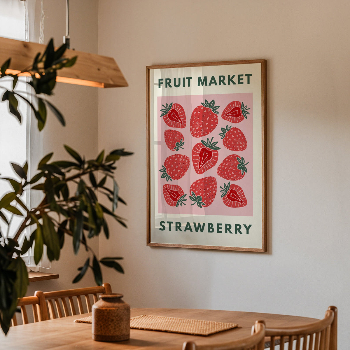 Fruit Market strawberry print in a walnut frame above a dining table with olive branches