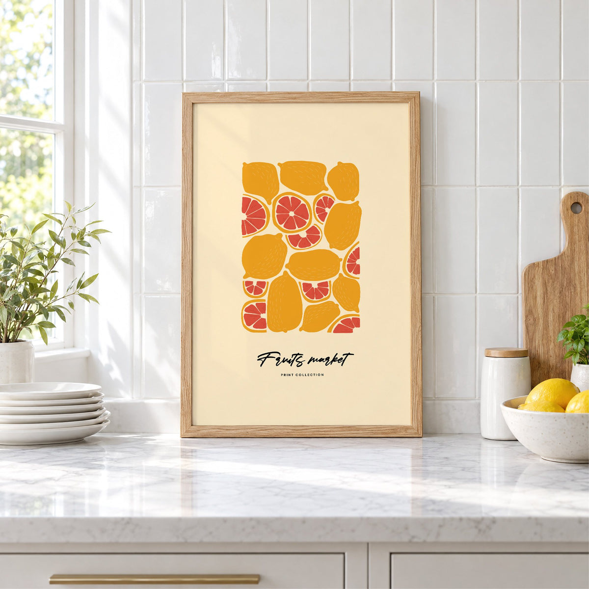 Fruits market citrus pattern print in an oak frame leaning on a marble counter by white tiles and lemons