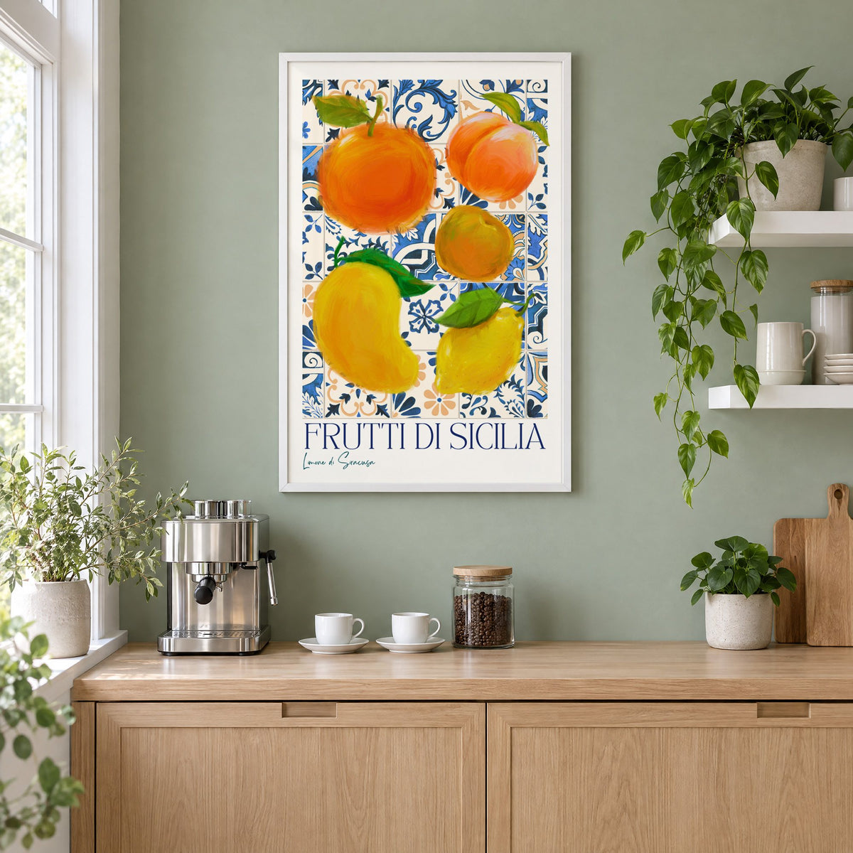 Frutti di Sicilia blue tile fruit print in a white frame on a sage green coffee nook wall above an espresso machine