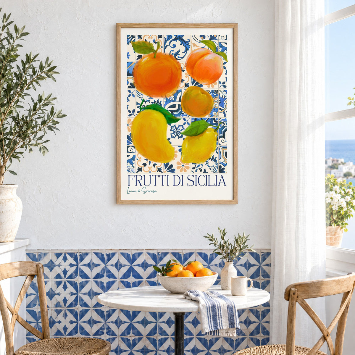 Frutti di Sicilia blue tile fruit print in an oak frame above a bistro table and blue patterned tiles