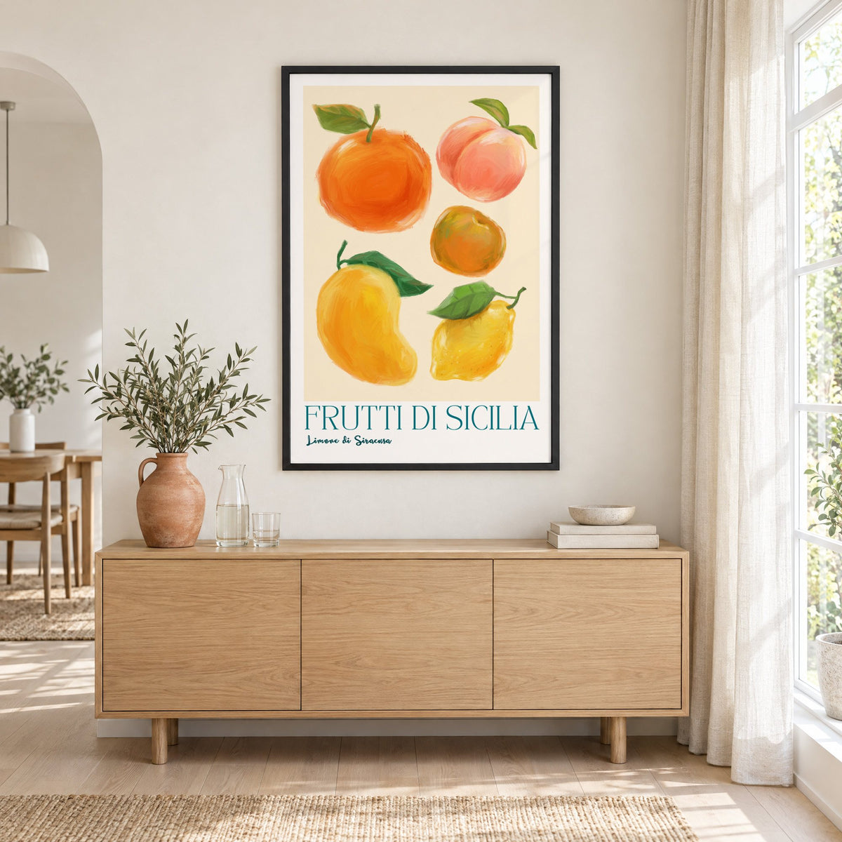 Frutti di Sicilia cream painted fruit print in a black frame above an oak sideboard with a terracotta vase of olive branches