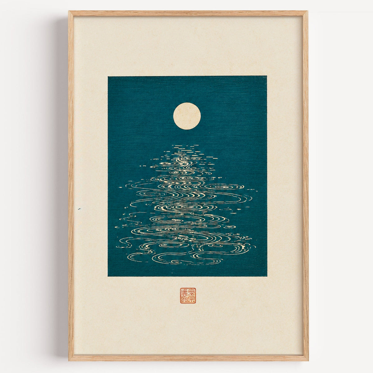 full moon over teal water print in a light oak frame on a plain white wall