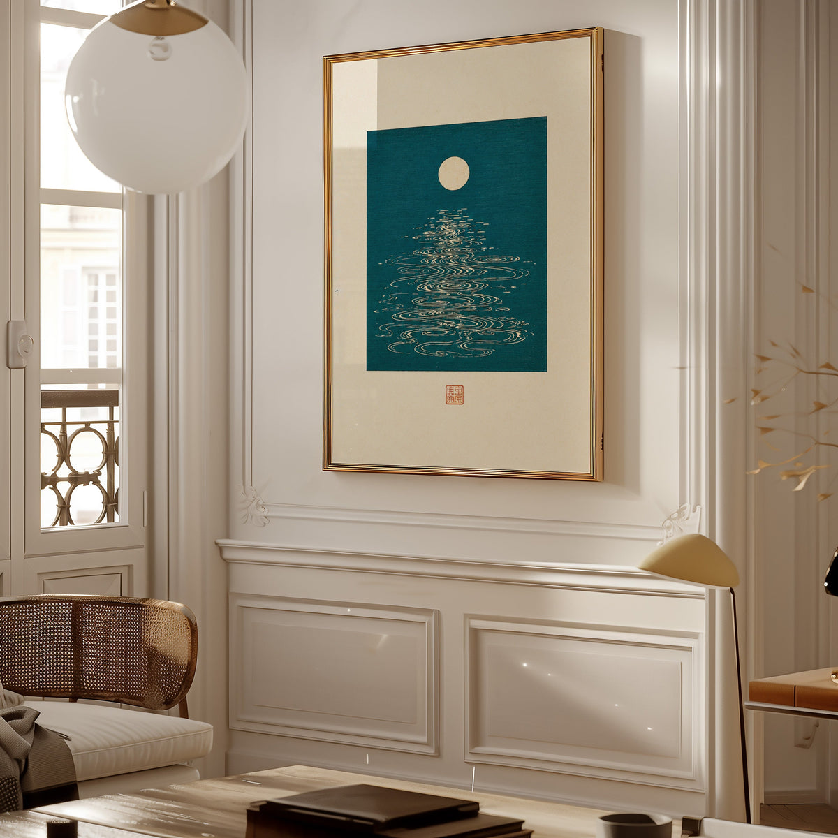 full moon over teal water print shown in a gold frame on a paneled wall in a Parisian-style living room