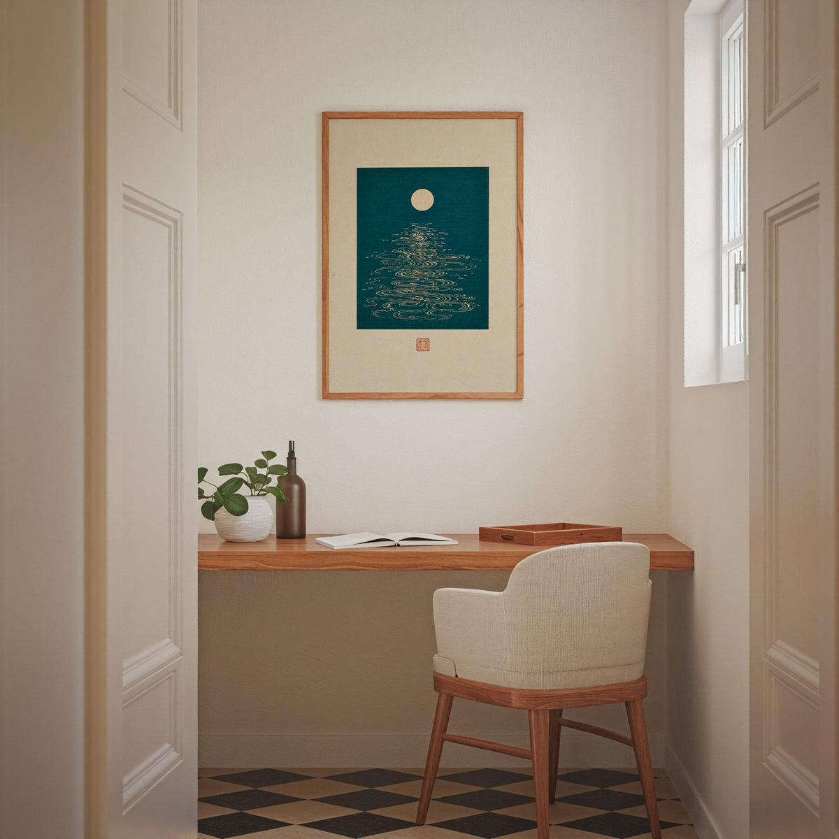 full moon over teal water print in an oak frame above a wall-mounted desk in a home office nook