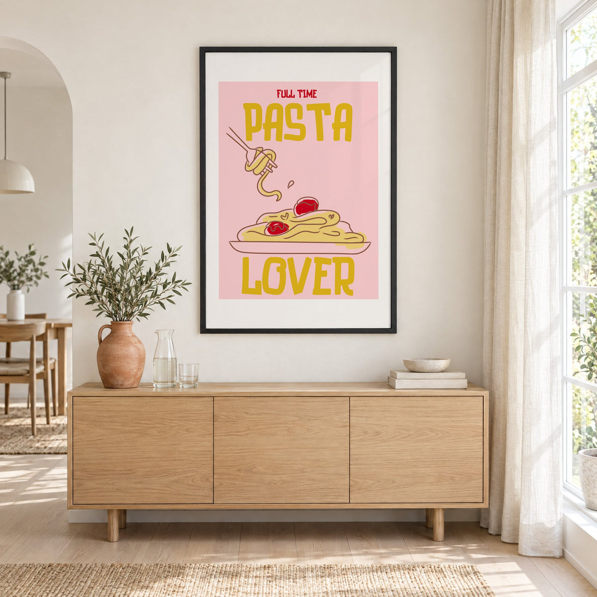 Full Time Pasta Lover spaghetti print in a black frame above an oak sideboard with a terracotta vase of olive branches