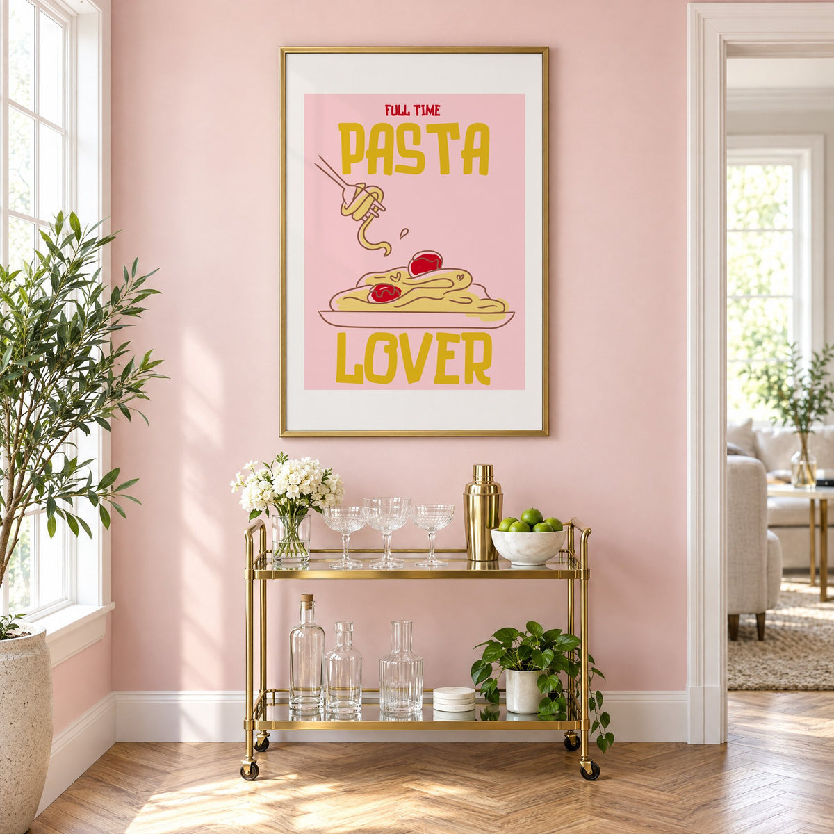 Full Time Pasta Lover spaghetti print in a brass frame above a gold bar cart on a blush pink wall