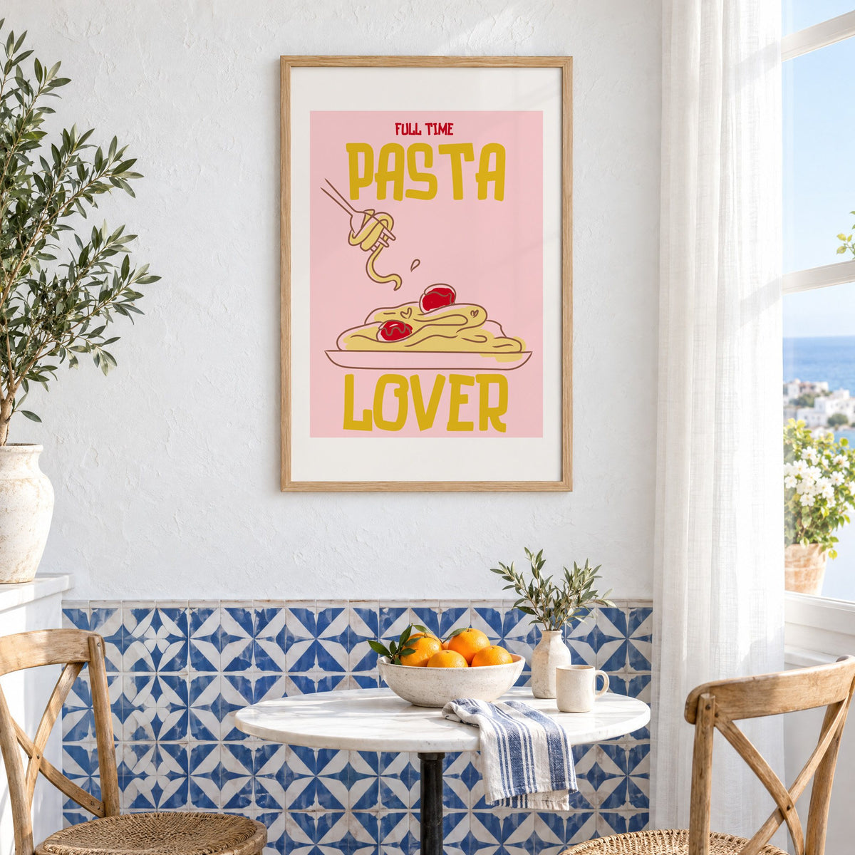 Full Time Pasta Lover spaghetti print in an oak frame above a bistro table and blue patterned tiles