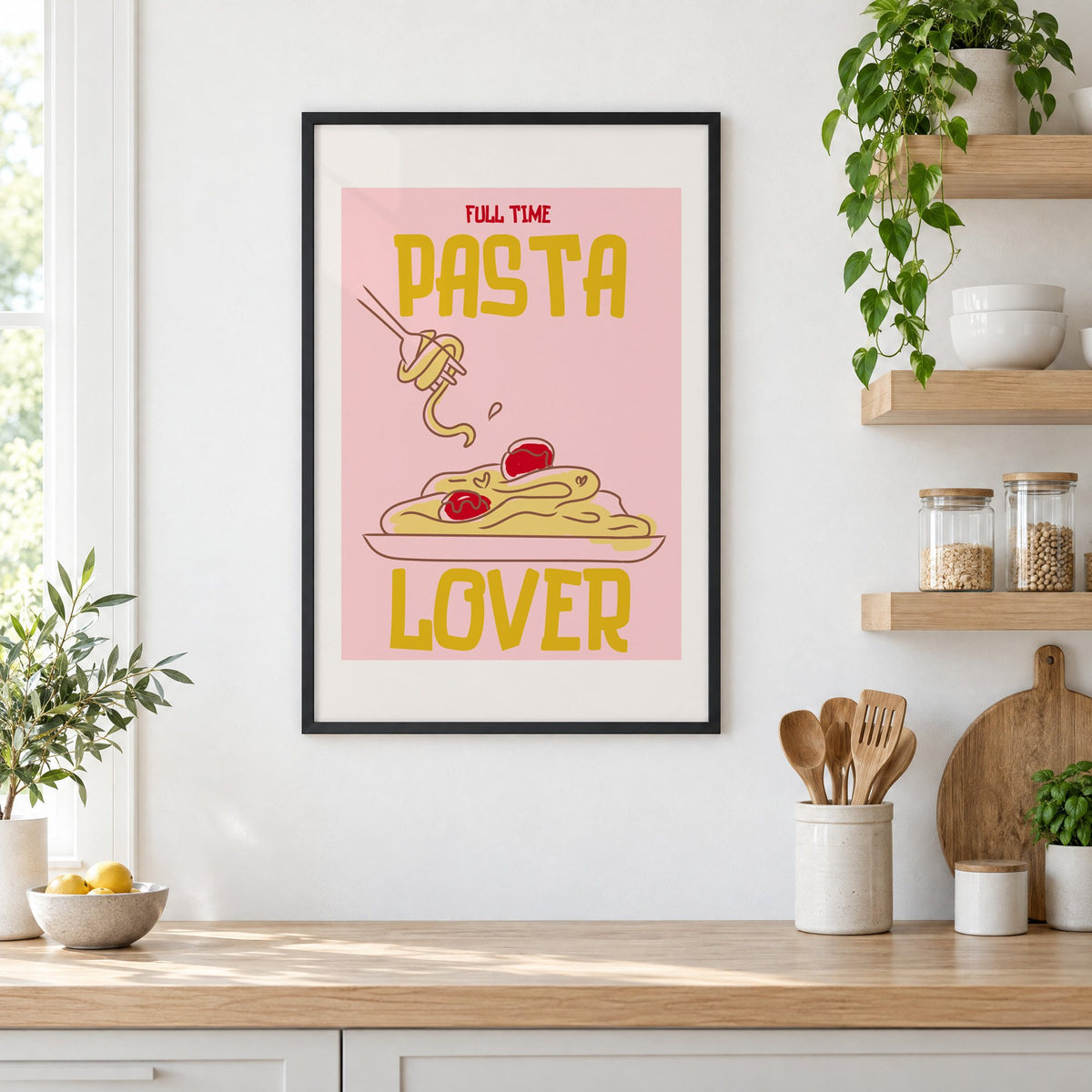Full Time Pasta Lover spaghetti print in a black frame in a white kitchen beside open wood shelves and glass jars