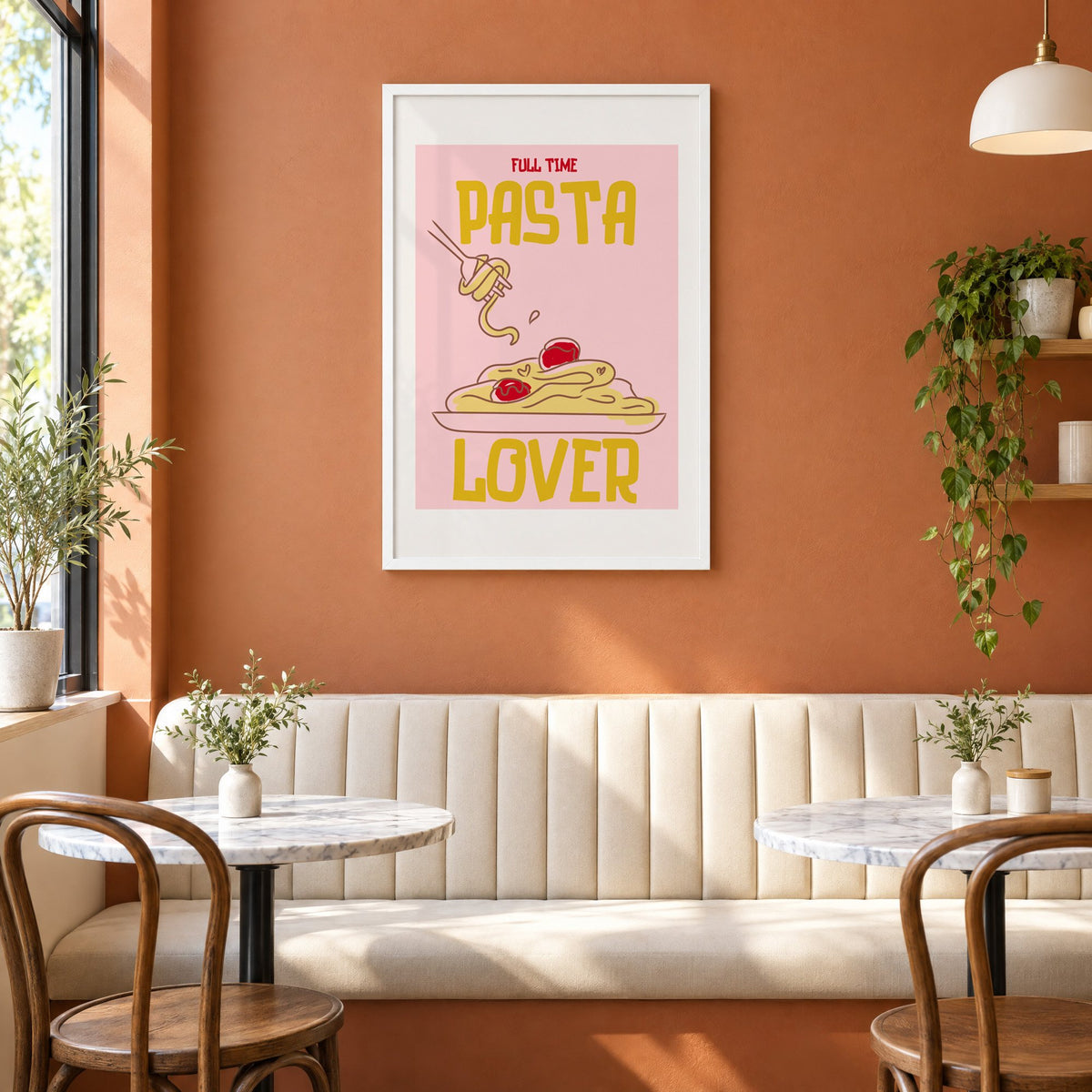 Full Time Pasta Lover spaghetti print in a white frame above a cream banquette on a terracotta cafe wall