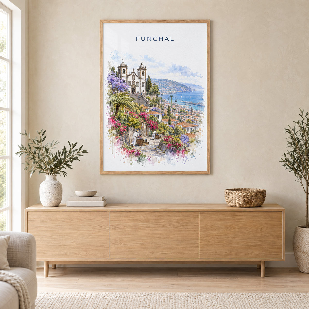 Funchal watercolor print in an oak frame above a light wood sideboard in a Scandinavian living room