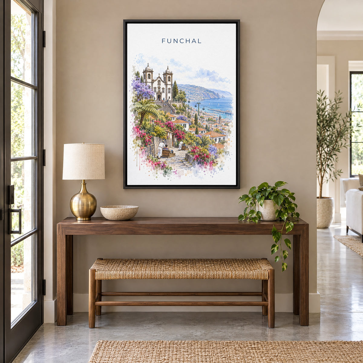 Funchal watercolor print as a black floater canvas above a walnut console and woven bench in an entryway